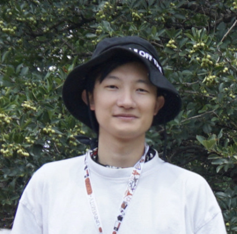 Jonas Yu Hong outdoors in floppy black hat