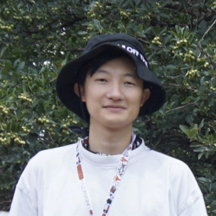 Jonas Yu Hong outdoors in floppy black hat